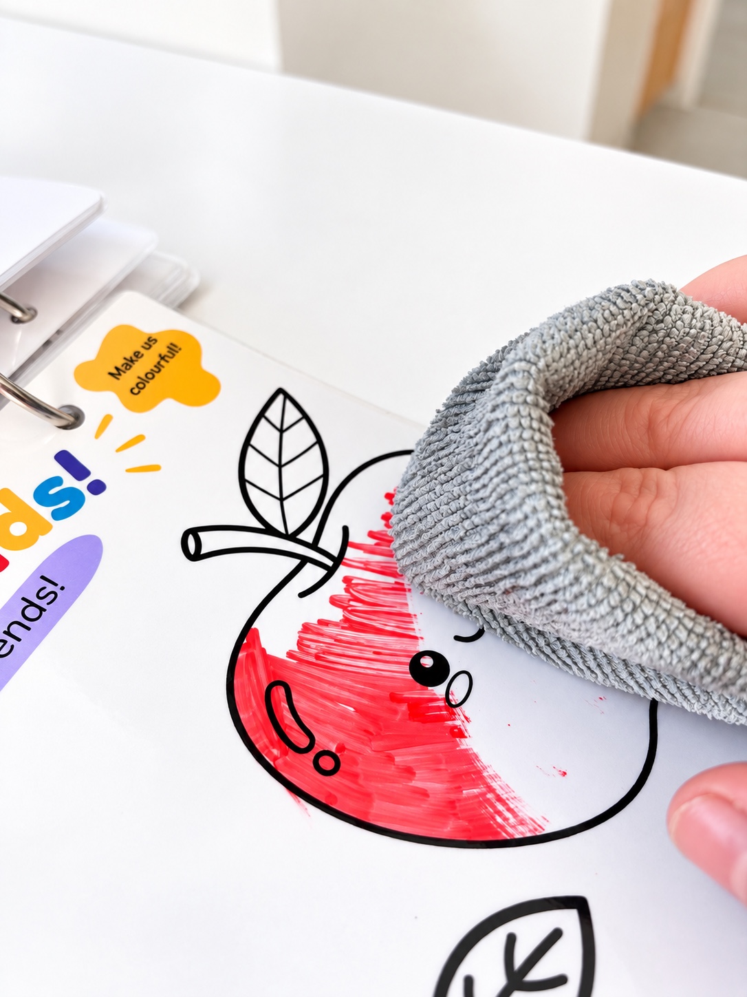 Colour being wiped from a laminated apple activity page